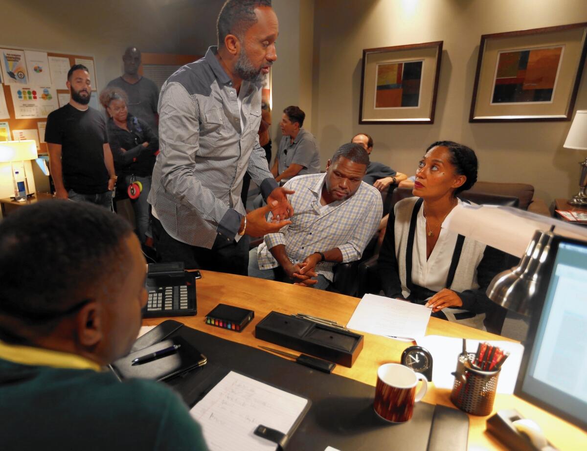 "Black-ish" creator Kenya Barris, left, talks with his actors Anthony Anderson (Dre Johnson) and Tracee Ellis Ross (Rainbow) during rehearsal.