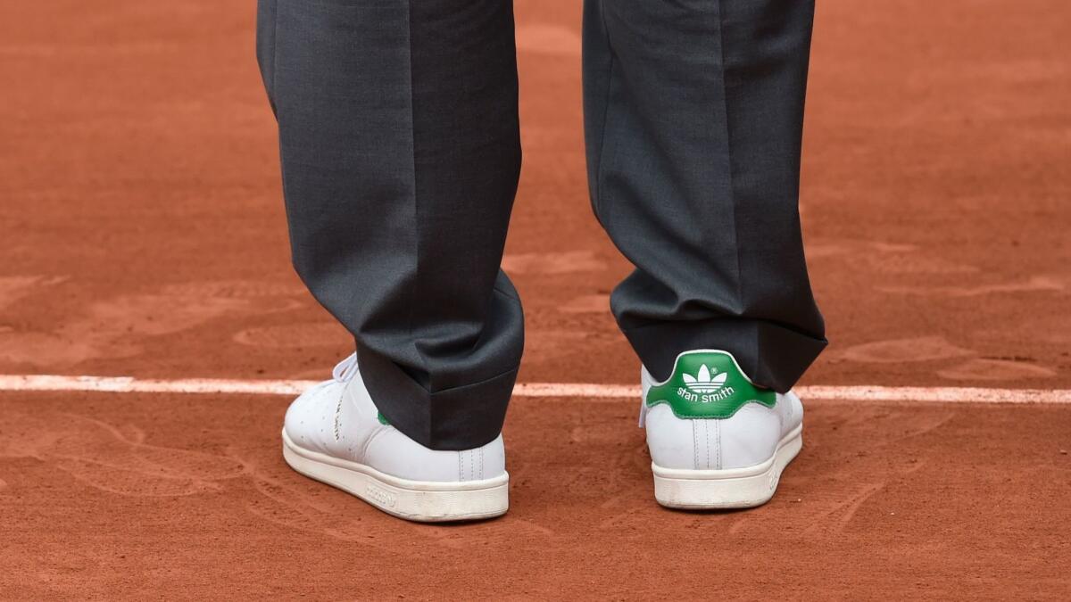 Stan Smith wears a pair of his namesake Adidas shoes during an International Tennis Hall of Fame event at the French Open in Paris in 2016.