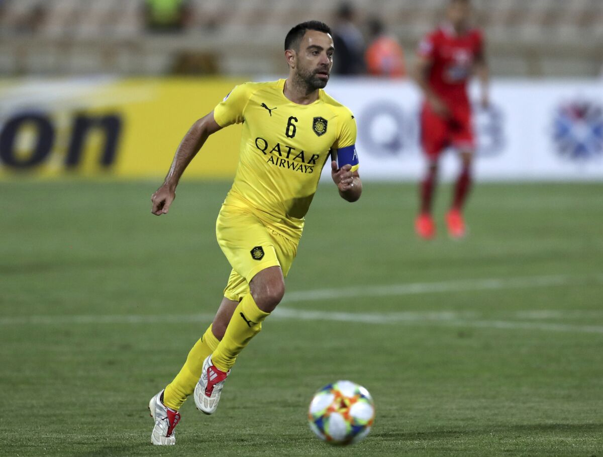 FILE - Qatar's Al-Sadd player Xavi Hernandez, former Barcelona and Spain midfielder, controls the ball during an AFC Champions League match at the Azadi stadium in Tehran, Iran, Monday, May 20, 2019. Barcelona is negotiating with Xavi Hernandez’s Qatari club Al-Sadd to seek his release so that the former star can return to Camp Nou as its new coach. (AP Photo/Vahid Salemi, File)