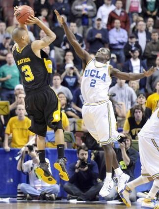 UCLA point guard Darren Collison gets a hand in the face of VCU's Eric Maynor as he takes a last-second shot on Thursday night.