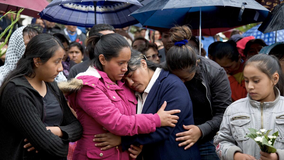 Patricia Sanchez Meza, mother of Jesus Cadena Sanchez is comforted by relatives at his funeral (Eduardo Verdugo / Associated Press)