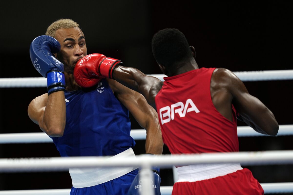 Keno Machado, of Brazil, right, punches Benjamin Whittaker, of Great Britain, during their light heavy weight 81kg quarterfinal boxing match at the 2020 Summer Olympics, Friday, July 30, 2021, in Tokyo, Japan. (AP Photo/Themba Hadebe)