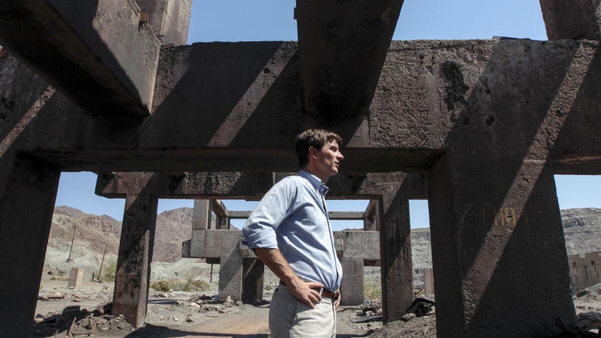 Steve Lowe, president of Eagle Crest Energy Co., stands amid the ruins of the ore loading area. (Irfan Khan / Los Angeles Times)