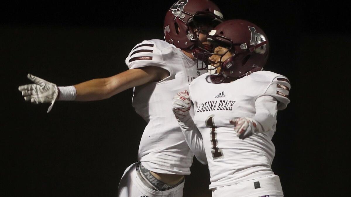 Laguna Beach High's Sean Nolan, left, celebrates his second touchdown with teammate Raul Villalobos during the first half against Marina in a nonleague game at Westminster High on Sept. 28.