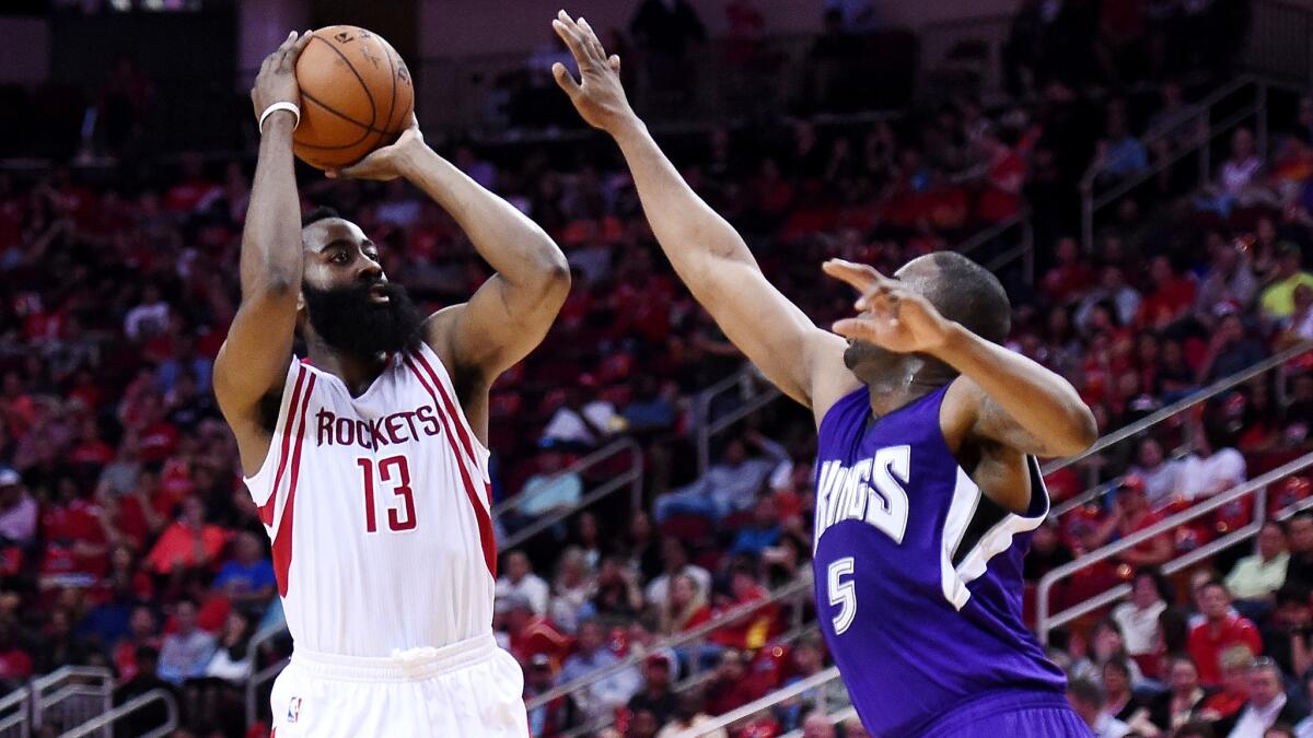 Rockets guard James Harden pulls up for a jump shot over Kings guard James Anderson during the first half Wednesday.