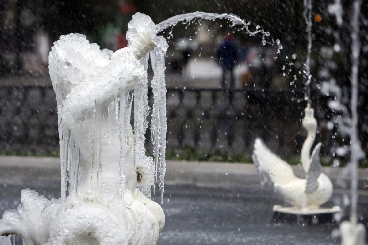 Water sputters through a frozen fountain in Historic Forsyth Park in Savannah, Ga., on Wednesday.