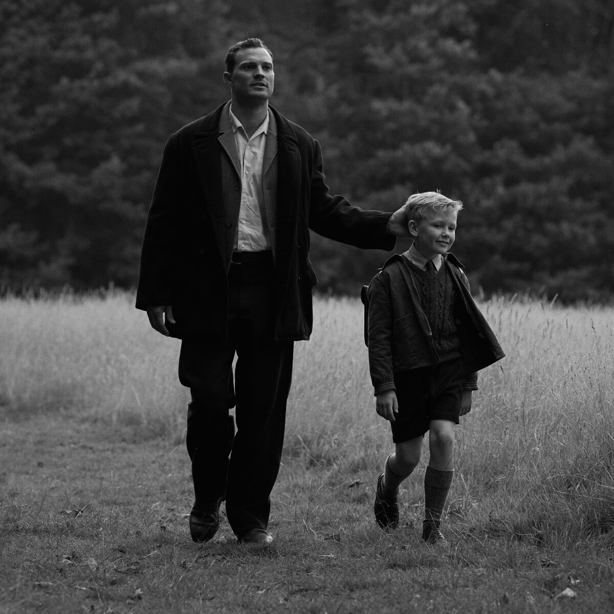 A man and a child go for a walk in the movie "Belfast."