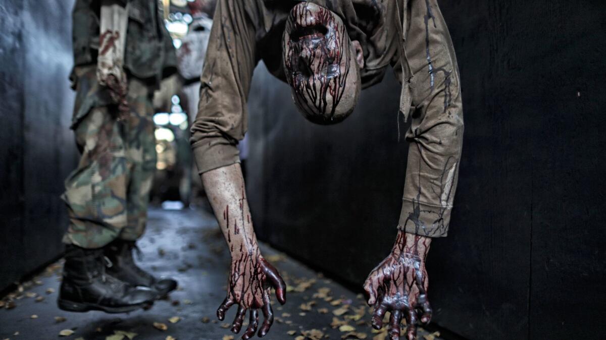 Fake corpses inside the Blumhouse of Horrors at Halloween Horror Nights at Universal Studios.