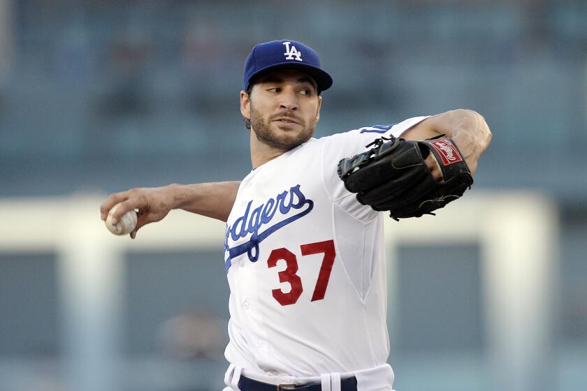 Dodgers starter Brandon Beachy delivers a pitch against the Brewers in the first inning Saturday night, completing his return from a second ligament replacement surgery on his right elbow.