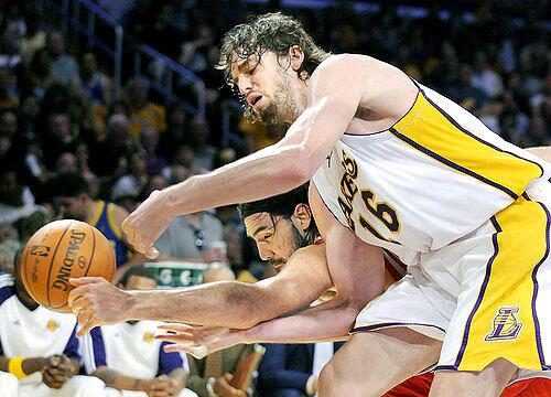 Lakers forward Pau Gasol and Houston forward Luis Scola go after a loose ball in Game 7 on Sunday.