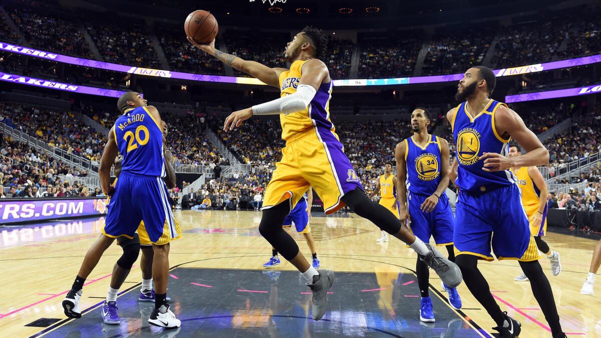 D'Angelo Russell scores a reverse layup against the Golden State Warriors in preseason play.