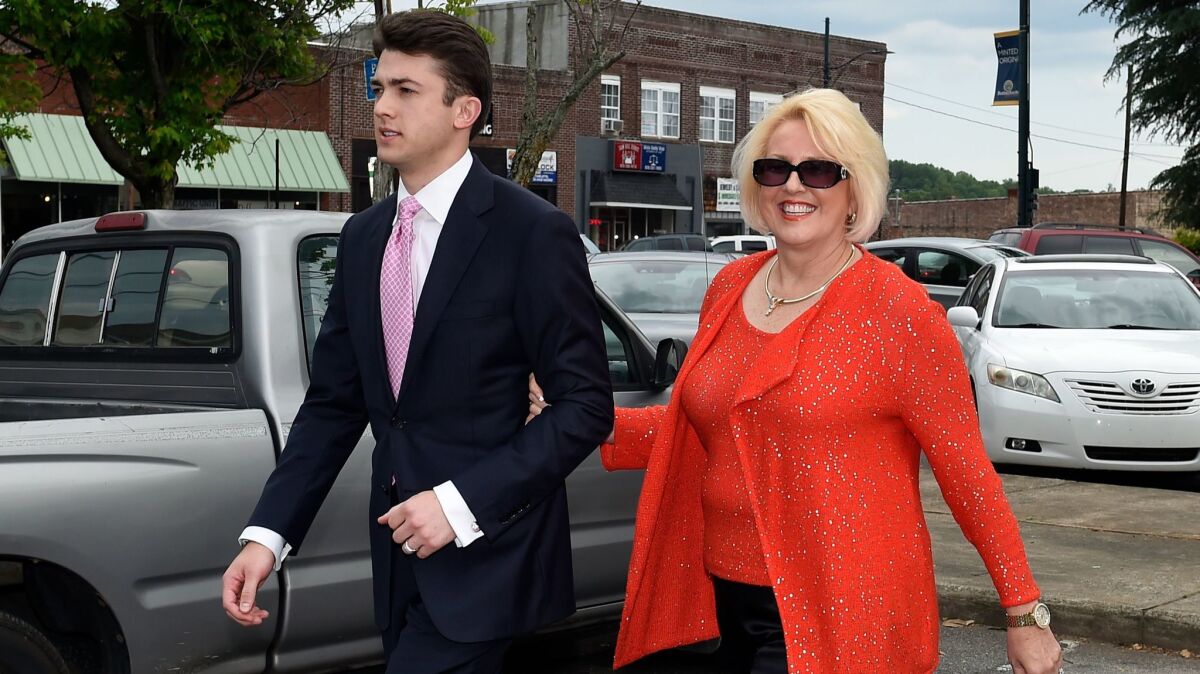Brooke Covington, a member of the Word of Faith Fellowship church in Spindle, N.C., leaves a hearing May 19, 2017, at Rutherford County Courthouse accompanied by attorney Joshua Valentine.
