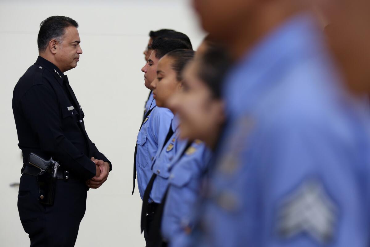 Jorge Villegas, pictured at a high school police academy graduation in 2016, was once living in the country illegally. Now, he is an assistant chief of the LAPD.