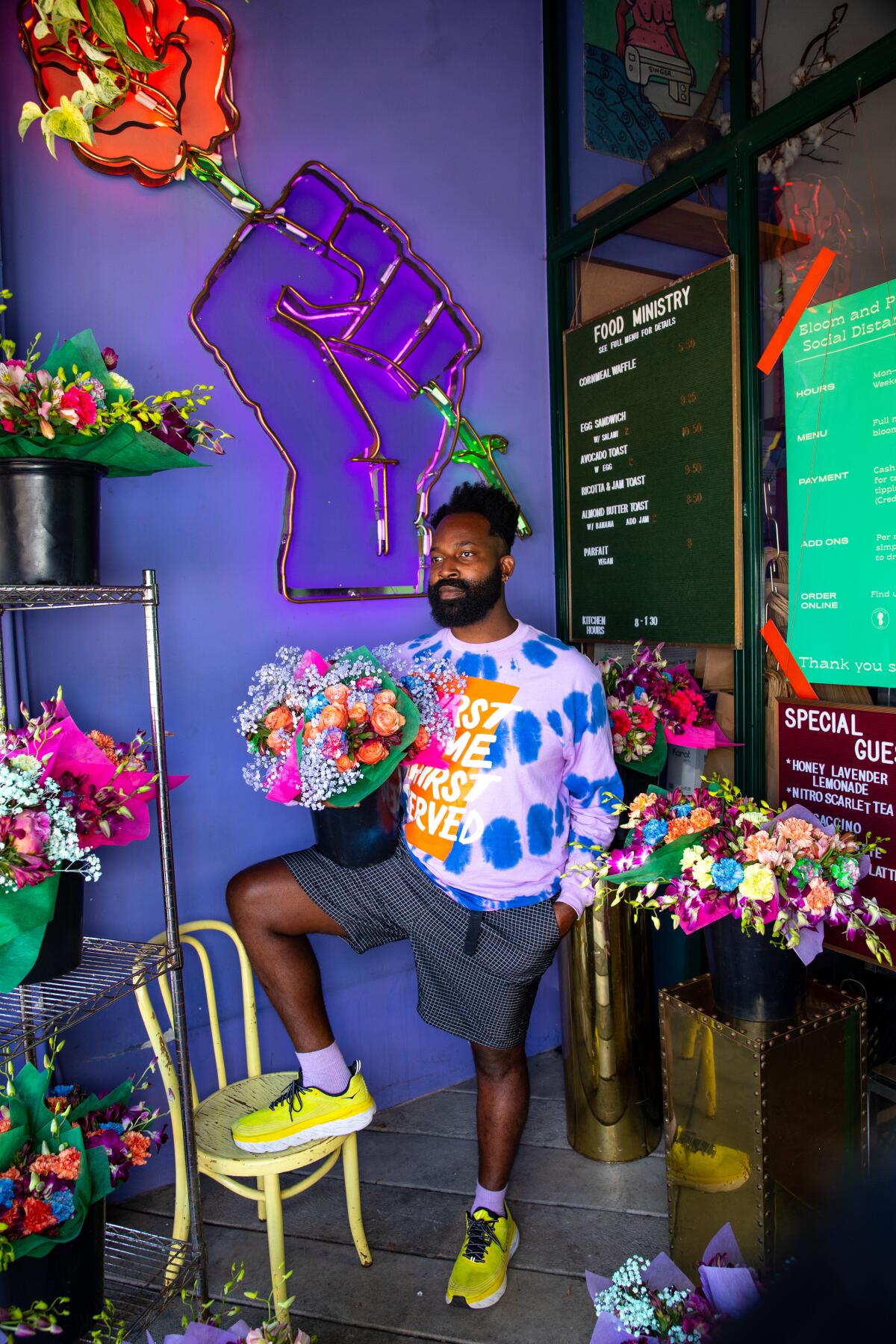 Maurice Harris surrounded by flowers in his store