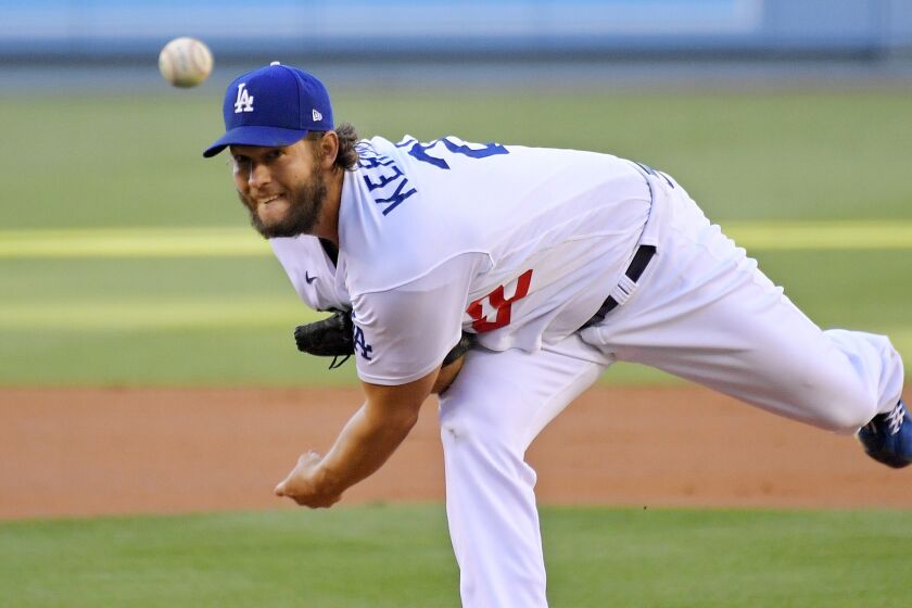 Los Angeles Dodgers starting pitcher Clayton Kershaw watches a throw during the first inning.