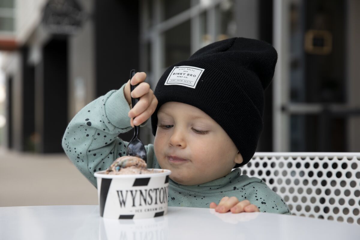 Benjamin Webster, 2, eats ice cream at Wynston's Ice Cream Co. on Tuesday in San Marcos.