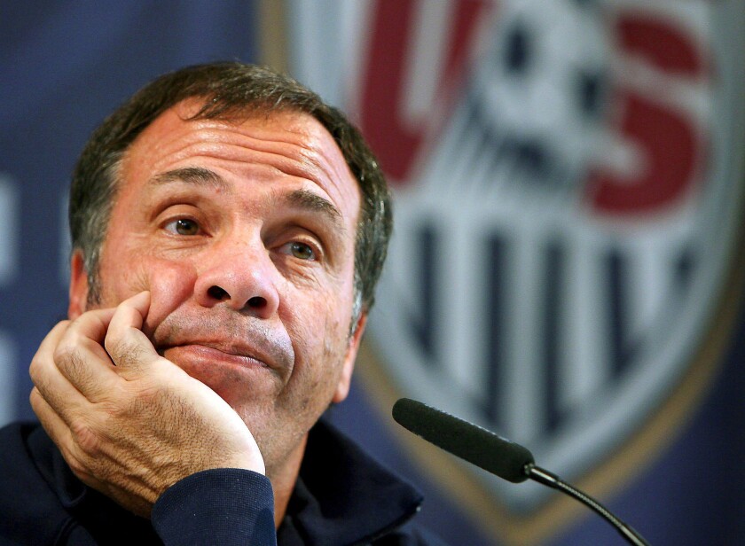 U.S. Coach Bruce Arena listens at a news conference in Hamburg, Germany, on June 13, 2006.