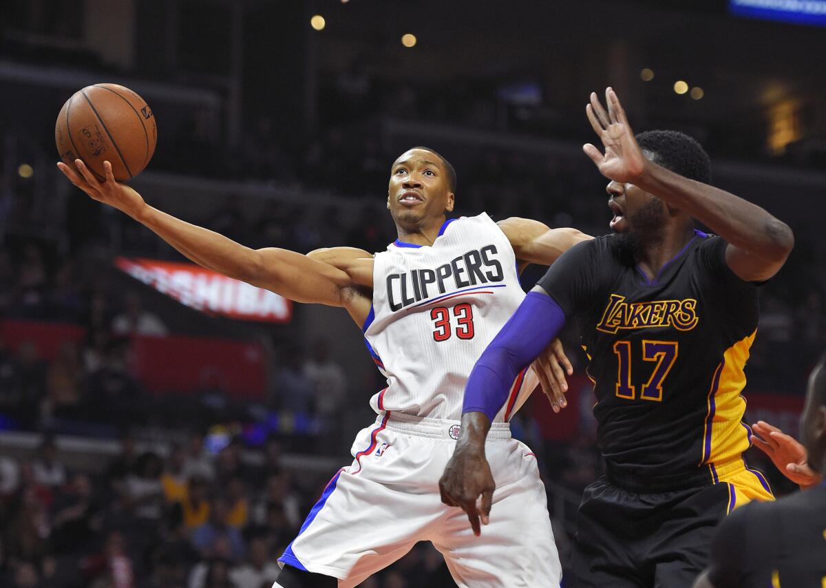 Clippers forward Wesley Johnson, left, shoots as Lakers center Roy Hibbert defends during the first half on Friday.