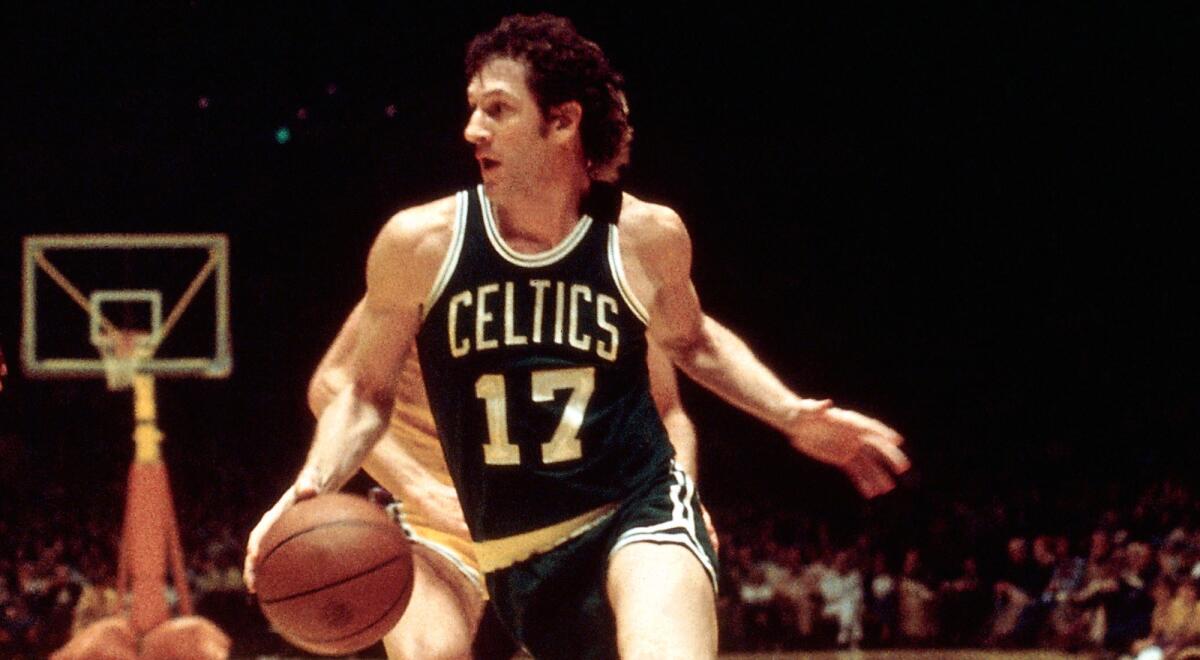 Celtics forward John Havlicek drives to the basket against the Lakers during an NBA game in 1970.