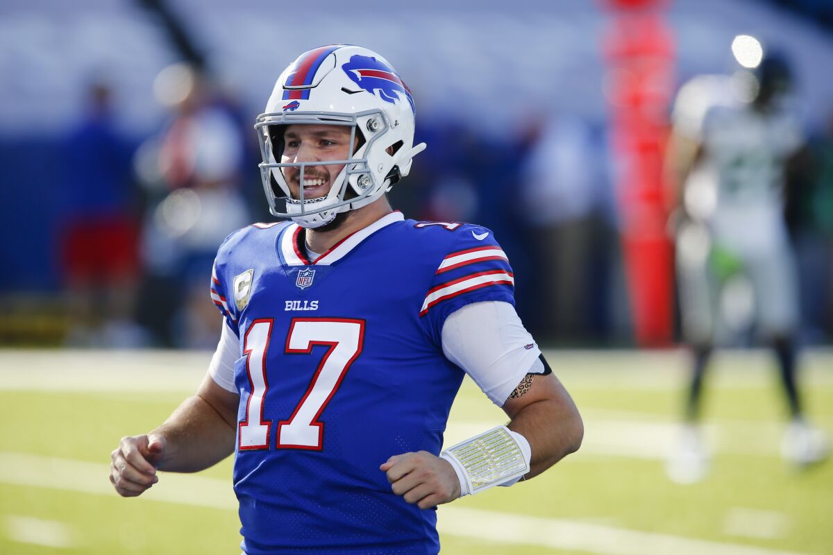 Buffalo Bills quarterback Josh Allen (17) smiles after throwing a touchdown pass to Isaiah McKenzie during the first half of an NFL football game against the Seattle Seahawks Sunday, Nov. 8, 2020, in Orchard Park, N.Y. (AP Photo/John Munson)
