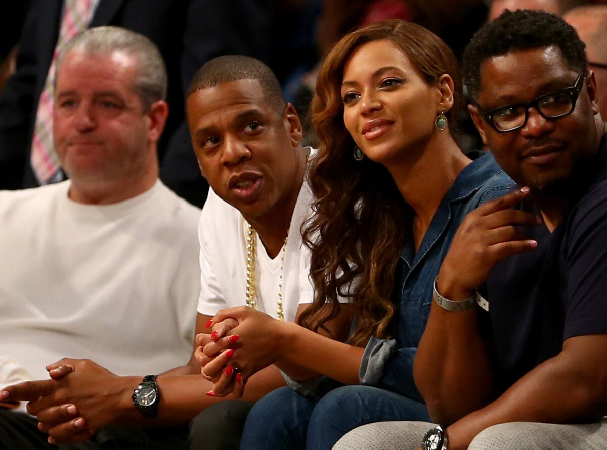 Jay Z, second from left, and Beyonce attend a semifinals game between the Brooklyn Nets and Miami Heat in New York City on Monday, the same day that video footage of an elevator fight involving them and Solange Knowles leaked online.