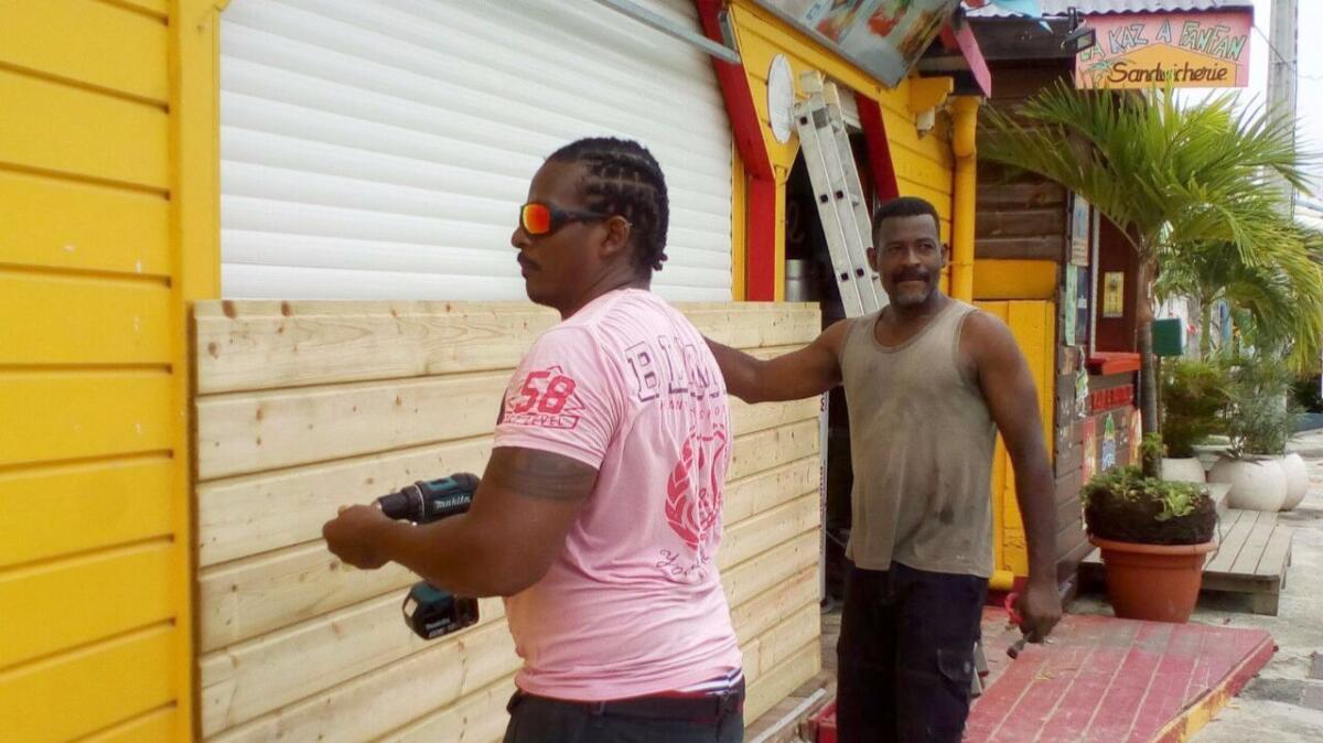 Men board up buildings ahead of Hurricane Maria in Sainte-Anne on the French Caribbean island of Guadeloupe on Monday.