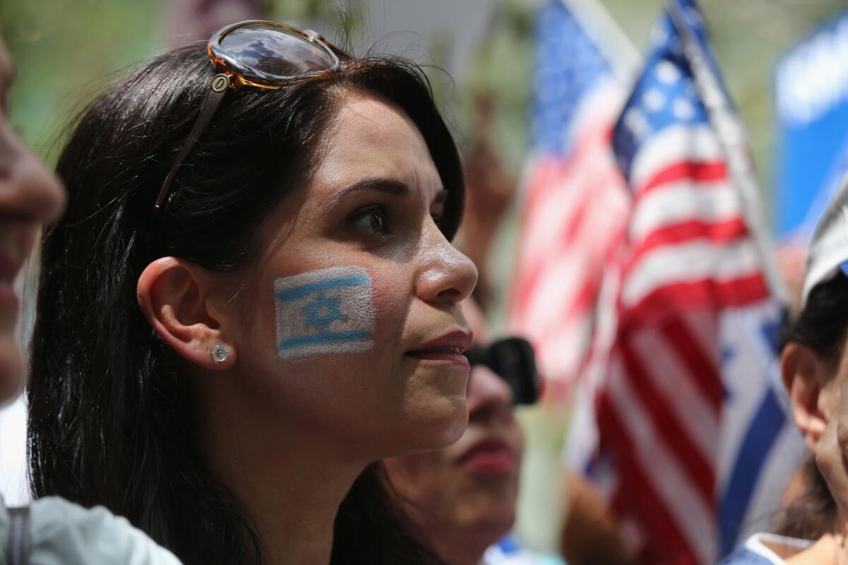 A woman takes part in a recent rally in support of Israel near the United Nations headquarters in New York City. A new poll shows most Americans continue to side with Israel in the conflict.