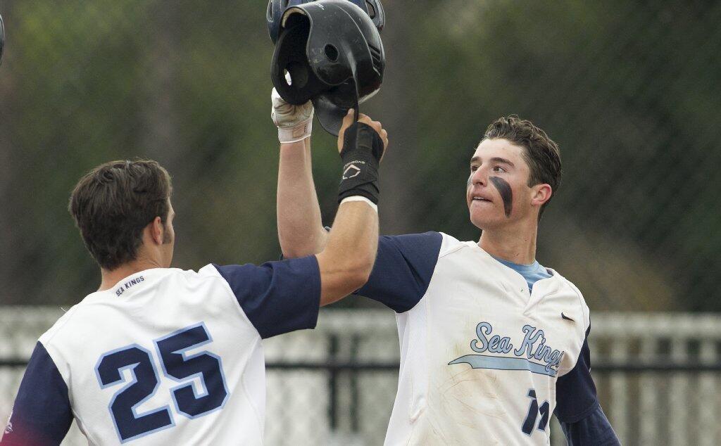 Corona del Mar's Preston Hartsell, left, congratulates JT Schwartz, right, after he hit a two-run home run in the fifth inning against Woodbridge in a Pacific Coast League game on Tuesday.