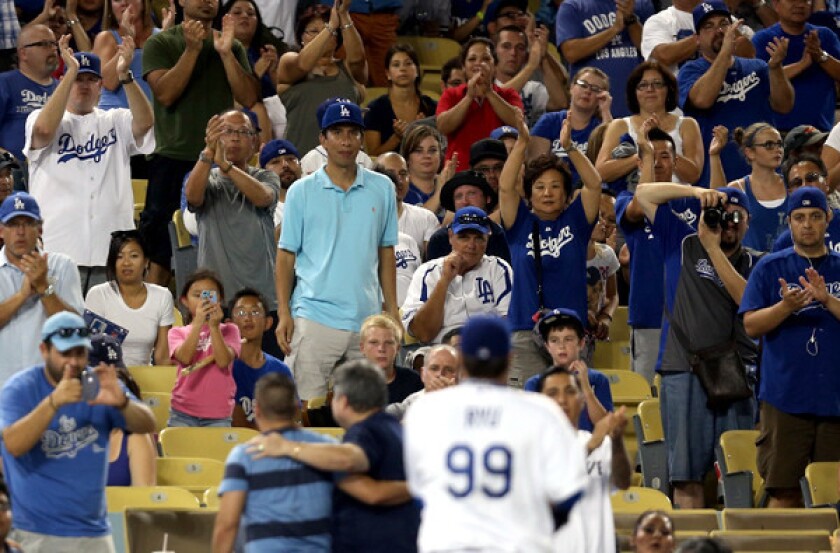 Fans at Dodger Stadium give pitcher Hyun-Jin Ryu an ovation as he comes out of a game against the San Diego Padres last month.