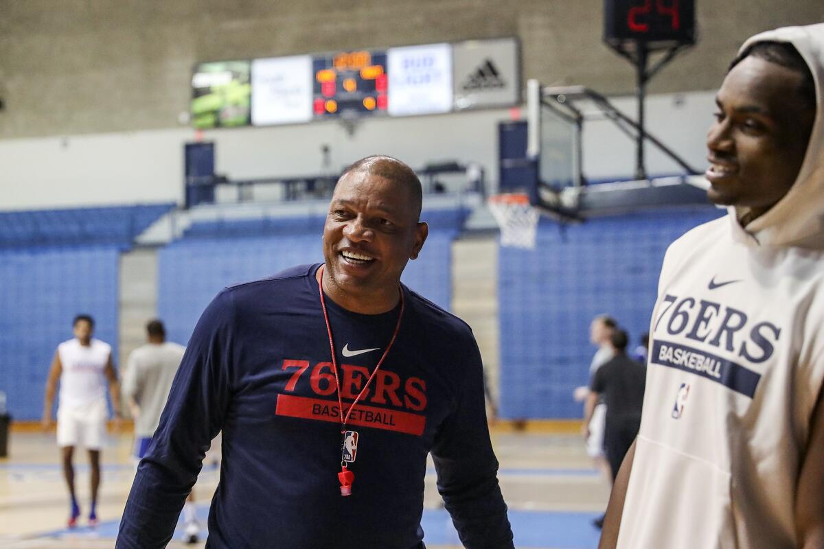 Philadelphia 76ers head coach Doc Rivers speaks with Danuel House after practice on the first day of Philadelphia 76ers NBA basketball training camp at the McAlister Field House on the campus of The Citadel in Charleston, S.C. on Tuesday, Sept. 27, 2022. (Heather Khalifa/The Philadelphia Inquirer via AP)