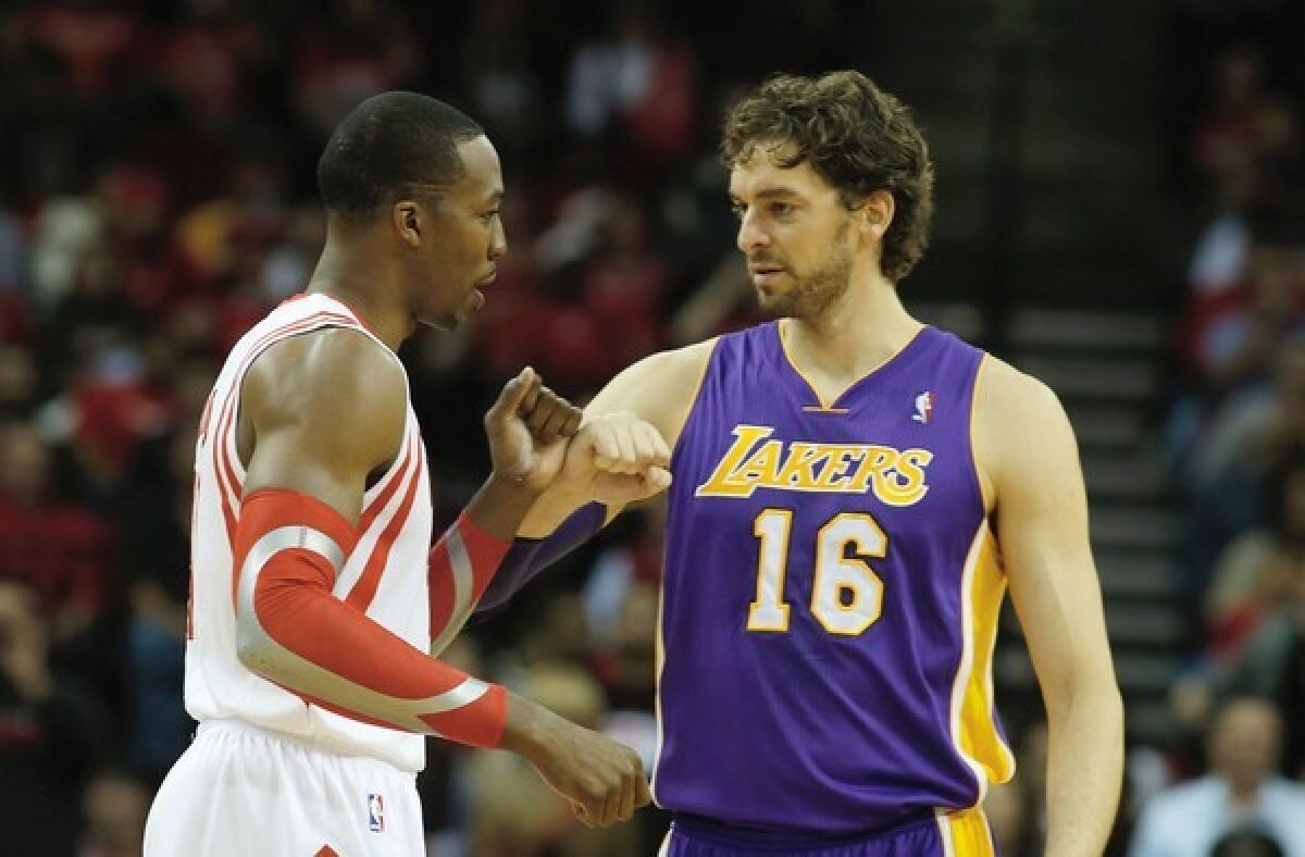 Rockets center Dwight Howard greets Lakers forward Pau Gasol before the start of their game in Houston.