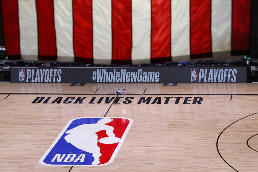 An empty court and bench are shown following the scheduled start time of Game 5 of an NBA basketball first-round playoff series, Wednesday, Aug. 26, 2020, in Lake Buena Vista, Fla. All three NBA playoff games scheduled for Wednesday were postponed, with players around the league choosing to boycott in their strongest statement yet against racial injustice. (Kevin C. Cox/Pool Photo via AP)