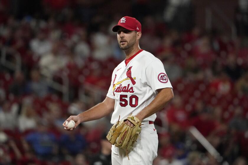 St. Louis Cardinals starting pitcher Adam Wainwright pauses after giving up a solo home run to Los Angeles Dodgers' Max Muncy during the sixth inning of a baseball game Wednesday, Sept. 8, 2021, in St. Louis. (AP Photo/Jeff Roberson)