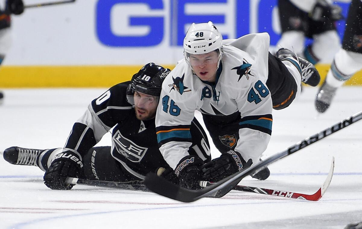 Mike Richards, left, and San Jose's Tomas Hertl dive for the puck during the Kings' 3-1 victory Saturday at Staples Center.