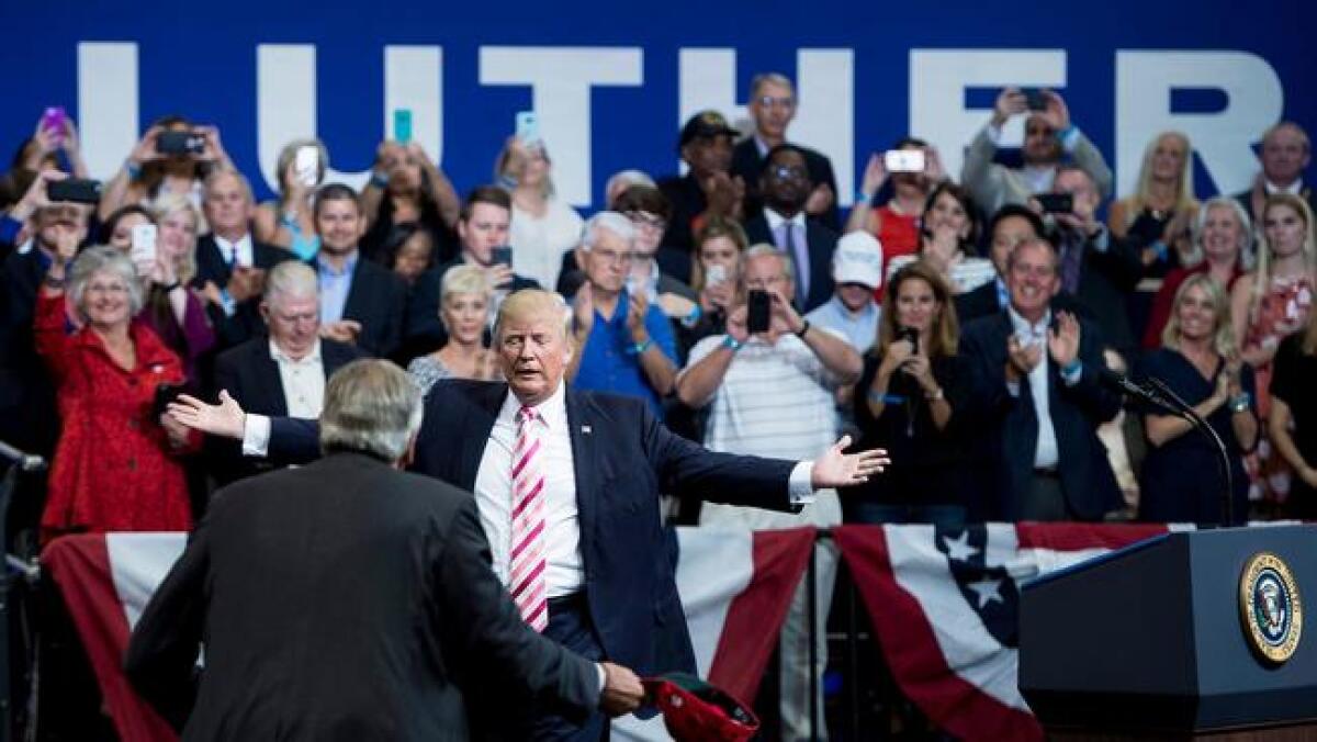 President Trump greets Sen. Luther Strange in Huntsville on Friday.