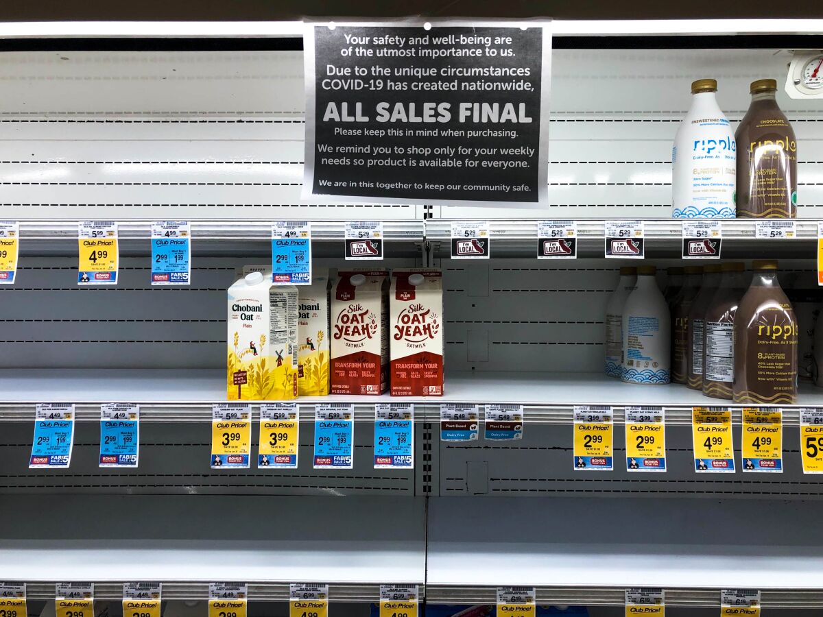 A scene from early in the pandemic, when shelves selling milk and milk alternatives were nearly empty at a supermarket.