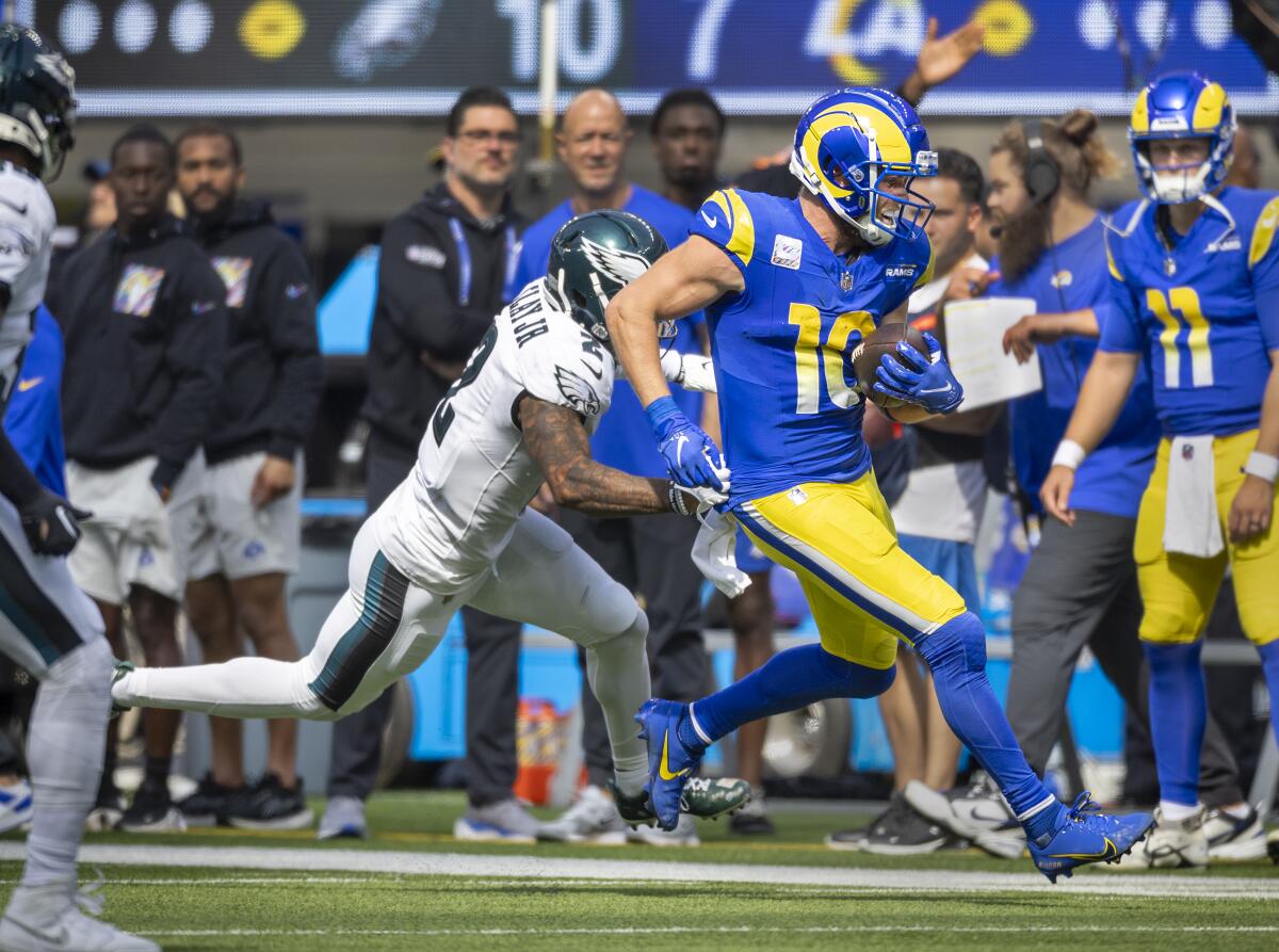Rams wide receiver Cooper Kupp runs with the ball in front of Philadelphia Eagles cornerback Darius Slay in the first half.