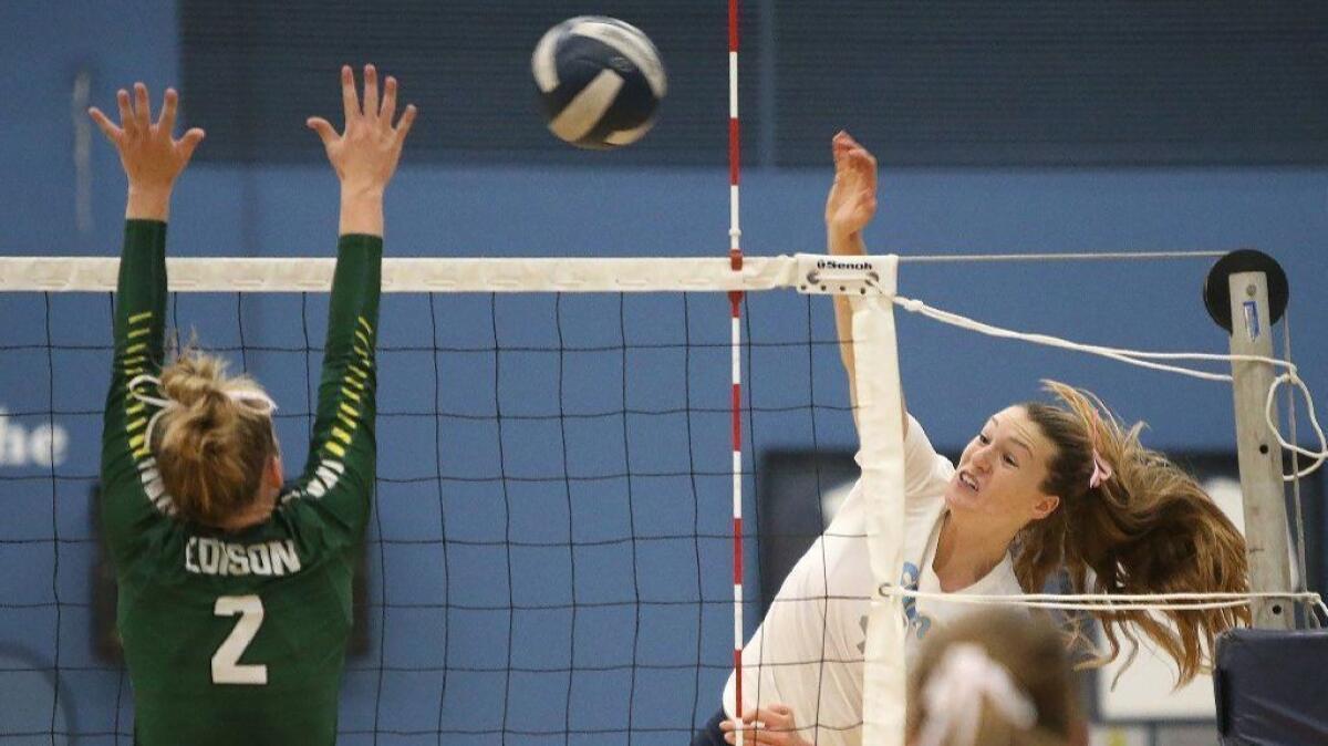 Corona del Mar High's Kendall Kipp, seen going wide of the net to put the ball in for a point past Edison's Aly Fullbright on Oct. 2, has signed with the Stanford women's volleyball program.