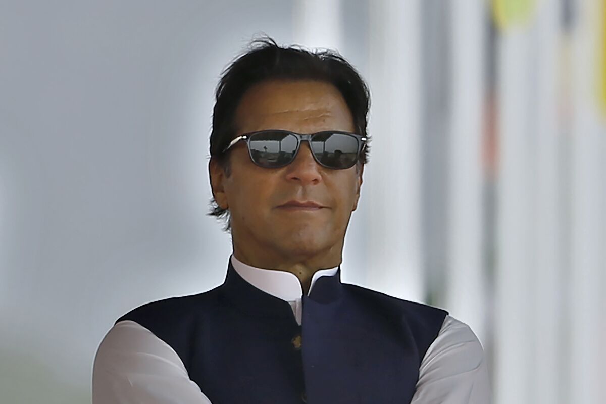 FILE - Pakistan's Prime Minister Imran Khan attends a military parade to mark Pakistan National Day, in Islamabad, Pakistan on March 23, 2022. Pakistan’s embattled prime minister faces a tough no-confidence vote Saturday, April 9, 2022, waged by his political opposition, which says it has the numbers to defeat him. (AP Photo/Anjum Naveed, File)