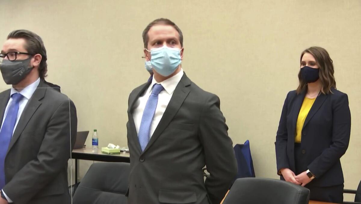 A file photo of a masked Derek Chauvin in court