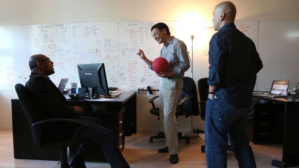 Second Spectrum CEO Rajiv Maheswaran, left, chats with COO Yu-Han Chang, center, and CTO Jeff Su in their office not far from Staples Center.