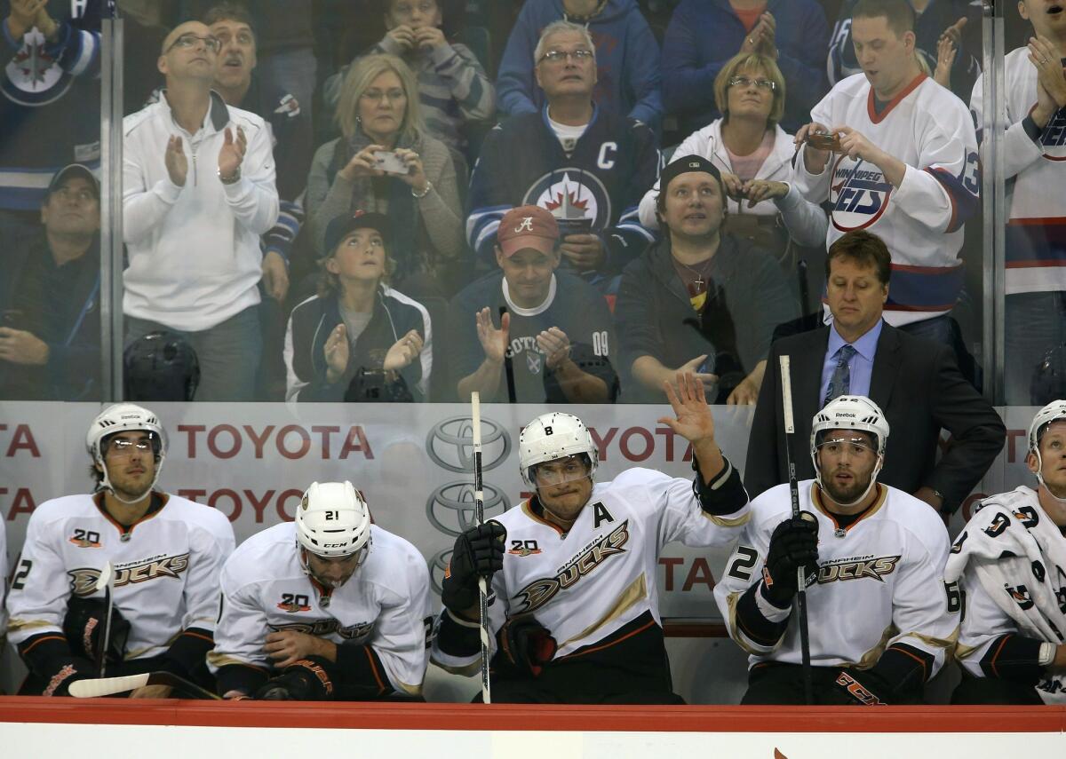 Ducks forward Teemu Selanne, center, acknowledges the crowd while receiving a standing ovation from Winnipeg Jets fans during Sunday's game.