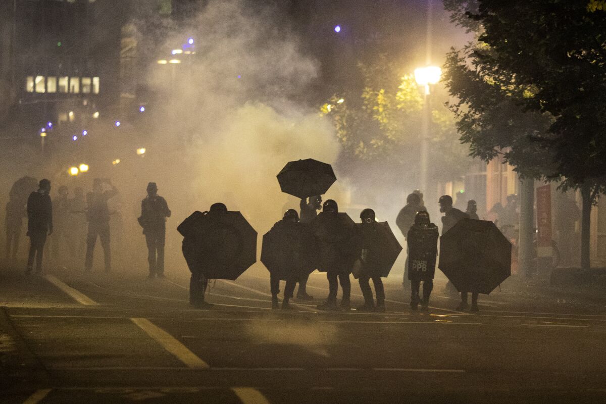 Tear gas fills the air during protests in Portland, Ore., on Sept. 18, 2020. 