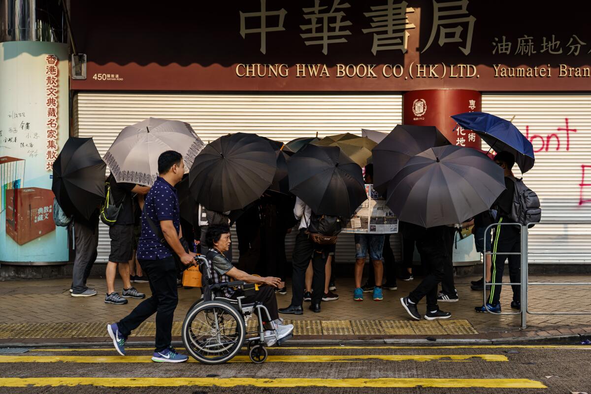 Anti-government protesters vandalize a store on Nathan Road in Hong Kong