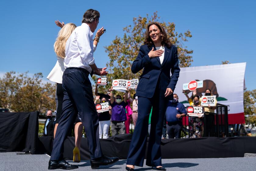 SAN LEANDRO, CA - SEPTEMBER 08: Vice President Kamala Harris, California Governor Gavin Newsroom and First Lady of California Jennifer Seibel-Newsom wave at a rally against the upcoming gubernatorial recall election at the IBEW-NECA Joint Apprenticeship Training Center on Wednesday, Sept. 8, 2021 in San Leandro, CA. The recall election, which will be held on September 14, 2021, asks voters to respond two questions: whether Newsom, a Democrat, should be recalled from the Office of Governor, and who would succeed Newsom should he be recalled. (Kent Nishimura / Los Angeles Times)
