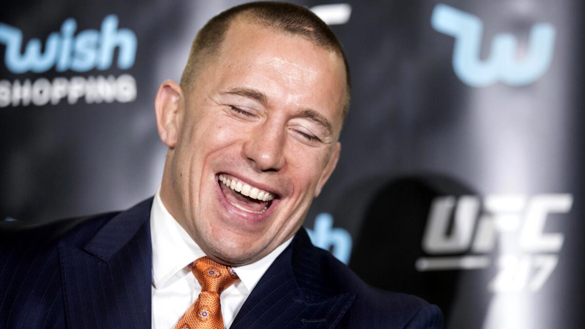 Georges St-Pierre has a laugh during a news conference in Toronto on Oct. 13 to promote the upcoming UFC 217.