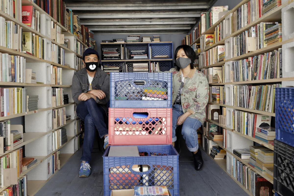 Chris Capizzi and Jenny Yang in one of the two Atwater Village storage lockers that hold inventory for their pop-up bookselling business, A Good Used Book.