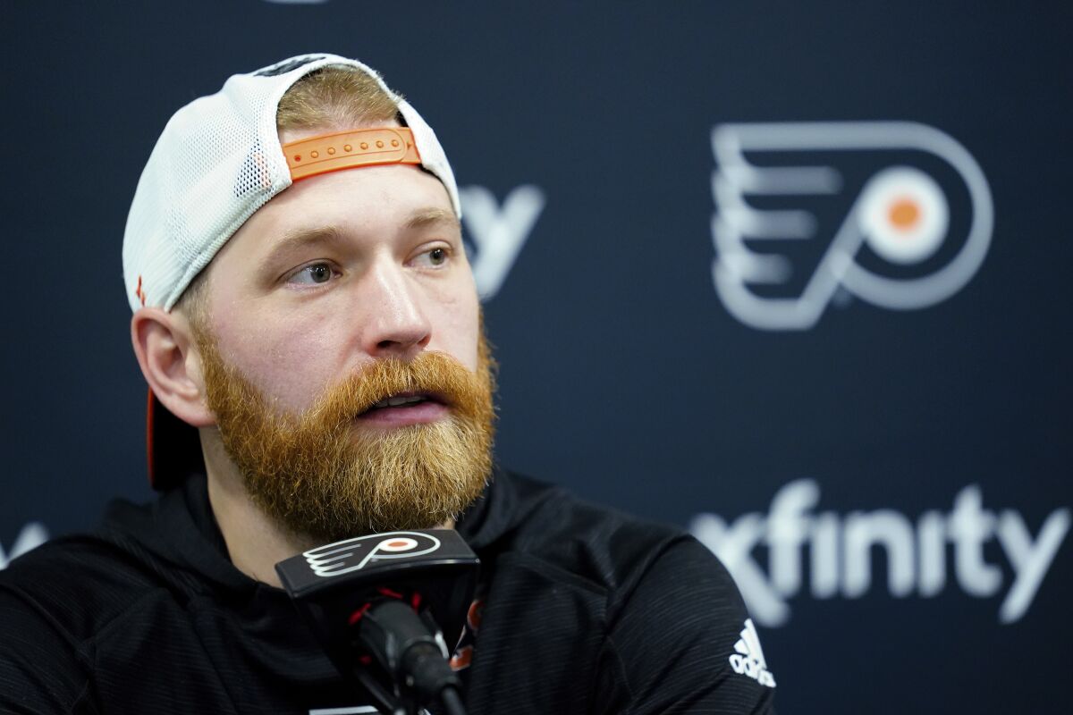 Philadelphia Flyers' Claude Giroux speaks with members of the media during a news conference at the team's NHL hockey practice facility, Wednesday, March 16, 2022, in Voorhees, N.J. Giroux's 1,000th career game with the Flyers on Thursday night could be his last in orange-and-black for the 34-year-old center approaching the final months of his contract. (AP Photo/Matt Rourke)