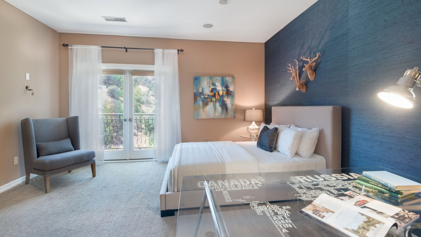 The roughly 5,900-square-foot home in Studio City was recently remodeled and features chrome accents, vibrant textiles and subdued hues, and an elevator.