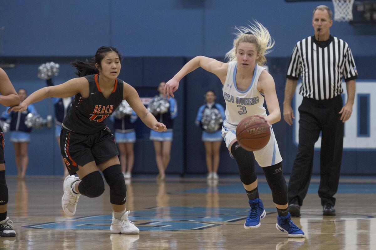 Corona del Mar's Haley Esquino advances the ball down the court as Huntington Beach's Akemi Tanga chases her during a Surf League game on Thursday.